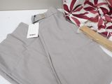 the pants are sitting on the table next to the bag