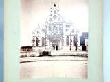 an old photo of a church with a clock tower in the middle of it