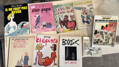a lot of books on the floor with pictures on them