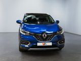 the front view of a blue renault kad suv parked in a showroom