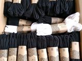 a box full of black yarn and a roll of white thread