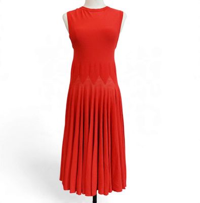 a red dress on a mannequin stand with a white background