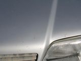 a close up of a car ' s headlight and the front end of it