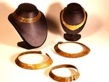 three pieces of jewelry that are sitting on a table