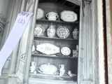 an open book with a picture of a china cabinet in it