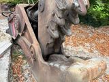 a statue of a man sitting on a bench in the park