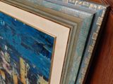 a picture of a painting on a bed with a wooden frame
