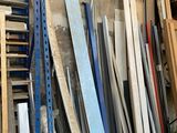 many pieces of wood stacked on a shelf in a garage