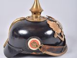 an old helmet with a gold crown on top of it