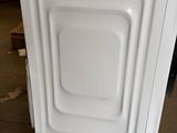 a white dishwasher sitting on top of a counter in a store