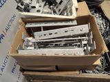 a box full of screws and bolts on the ground