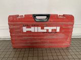 an old red tool box sitting on top of a tiled floor