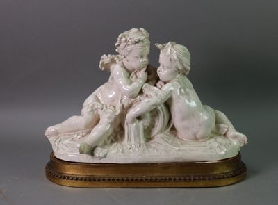 a figurine of a boy and a girl sitting on a bench