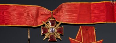 a red ribbon with a gold cross and a star on it