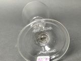 a glass that has a label on it on a table