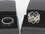 two rings in a black box on a white surface