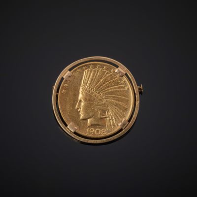 un gros plan d'une pièce d'or à l'effigie d'un Indien