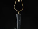 a black and gold table lamp on a white surface
