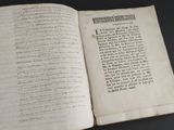 an open book with writing on it sitting on a table