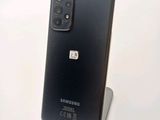 the back of a black samsung galaxy s20 with a small sim card attached to it