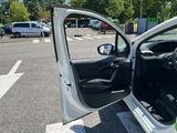 a white car with its door open in a parking lot