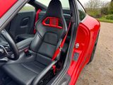 a red car with black leather seats and a steering wheel