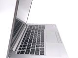 a silver laptop with a black keyboard on a white surface