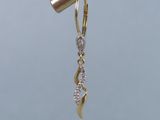 a close up of a pair of earrings hanging from a wire