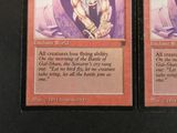 two cards that have a picture of a man holding a sword