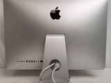 a silver apple computer with a cable connected to it