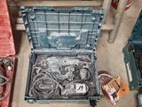 many different tools in a plastic box on the floor