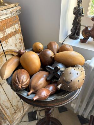 a bowl of gourds on a table in a room
