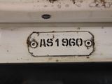 a rusted sign on the back of a white stove