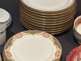 many plates and cups that are sitting on a table