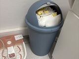 a trash can and a trash can in the corner of a kitchen