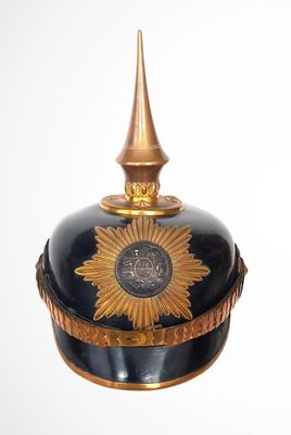 a black and gold hat with a gold star on it