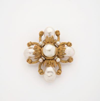 an image of a gold and pearl broochle on a white background