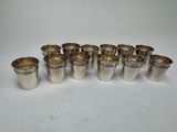 un lot de six verres à shot en argent à bord doré