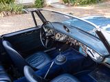 a blue car that is parked in a lot