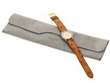 a close up of a watch with a case on a white background