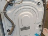 a white washer sitting on a wooden pallet in a room
