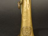 an old brass trumpet with a brass bell on a black background