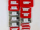 six red plastic boxes with labels on them sitting on a white surface