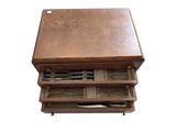 a small wooden table with a drawer full of utensils