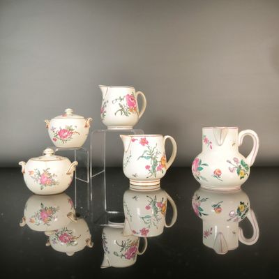 a group of teapots and tea cups on a table