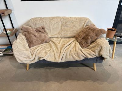 un ours en peluche allongé sur un canapé