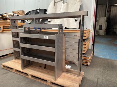 a metal rack with several shelves on it in a warehouse