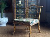 a chair that is sitting in front of a cabinet