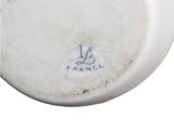 a close up of a white plate with blue writing on it