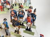 many figurines of soldiers on display in a display case
